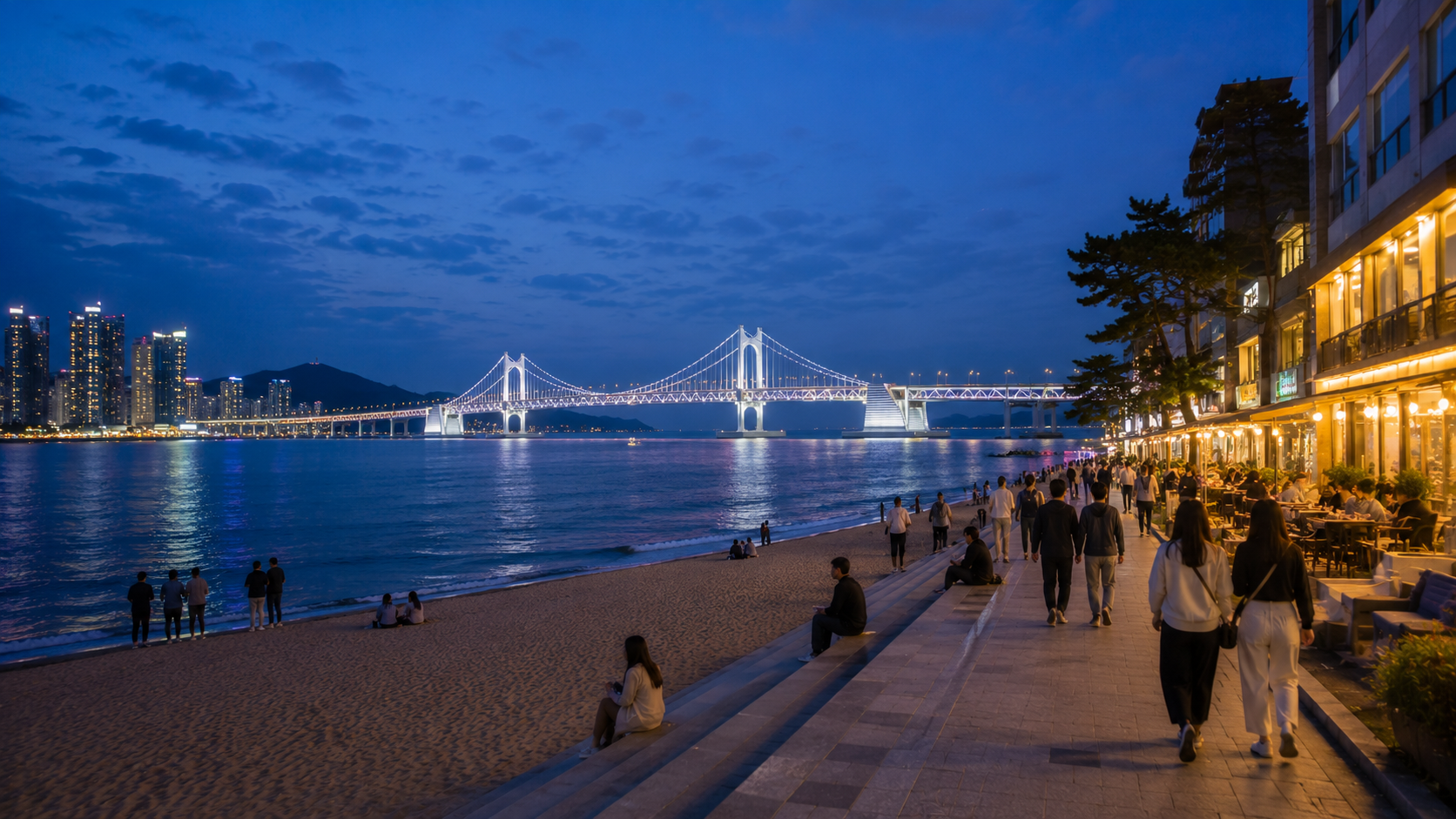 Gwangalli Beach at blue hour with Gwangan Bridge illuminated across the water
