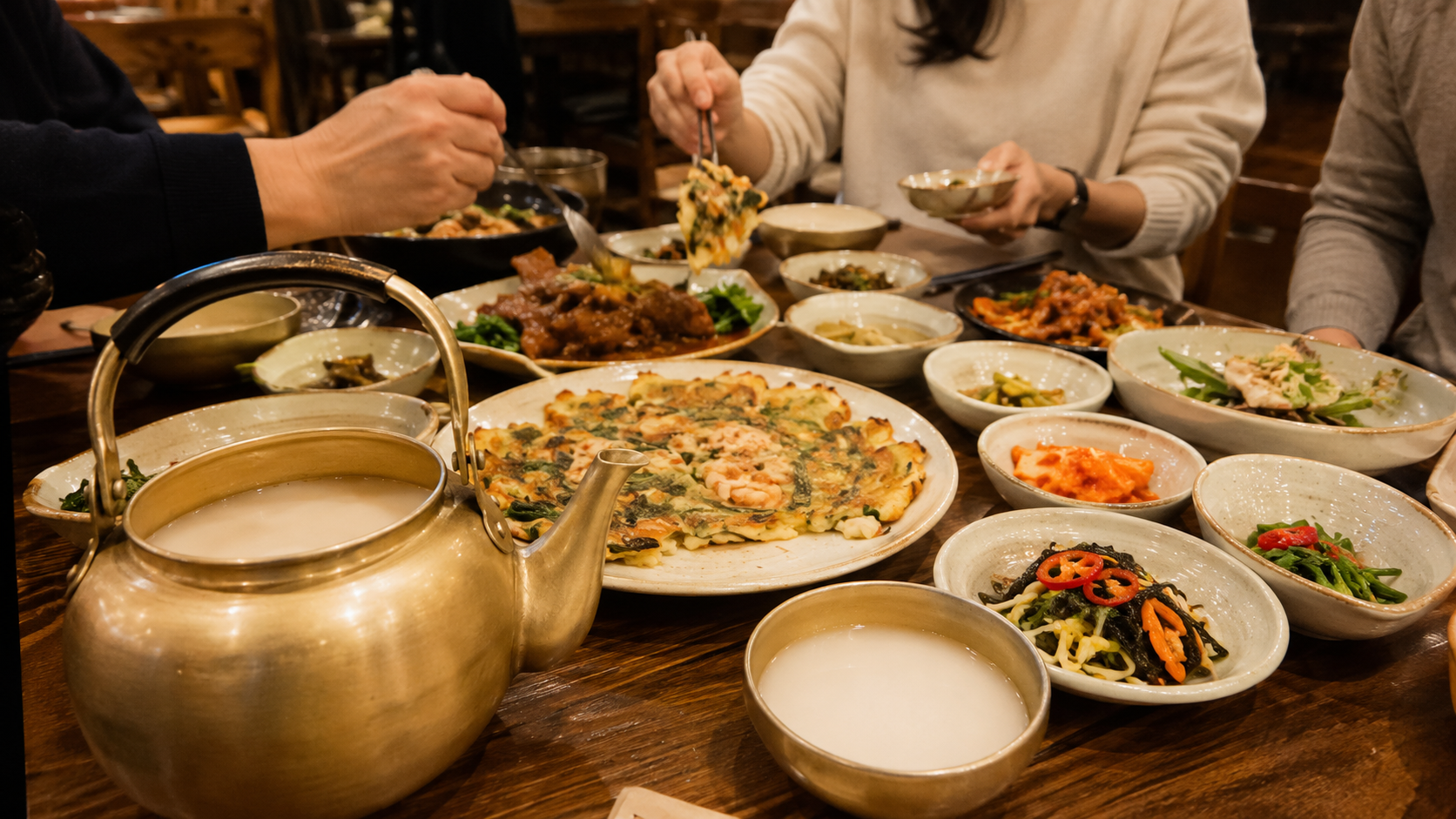 Evening meal with makgeolli and multiple shared dishes in Jeonju