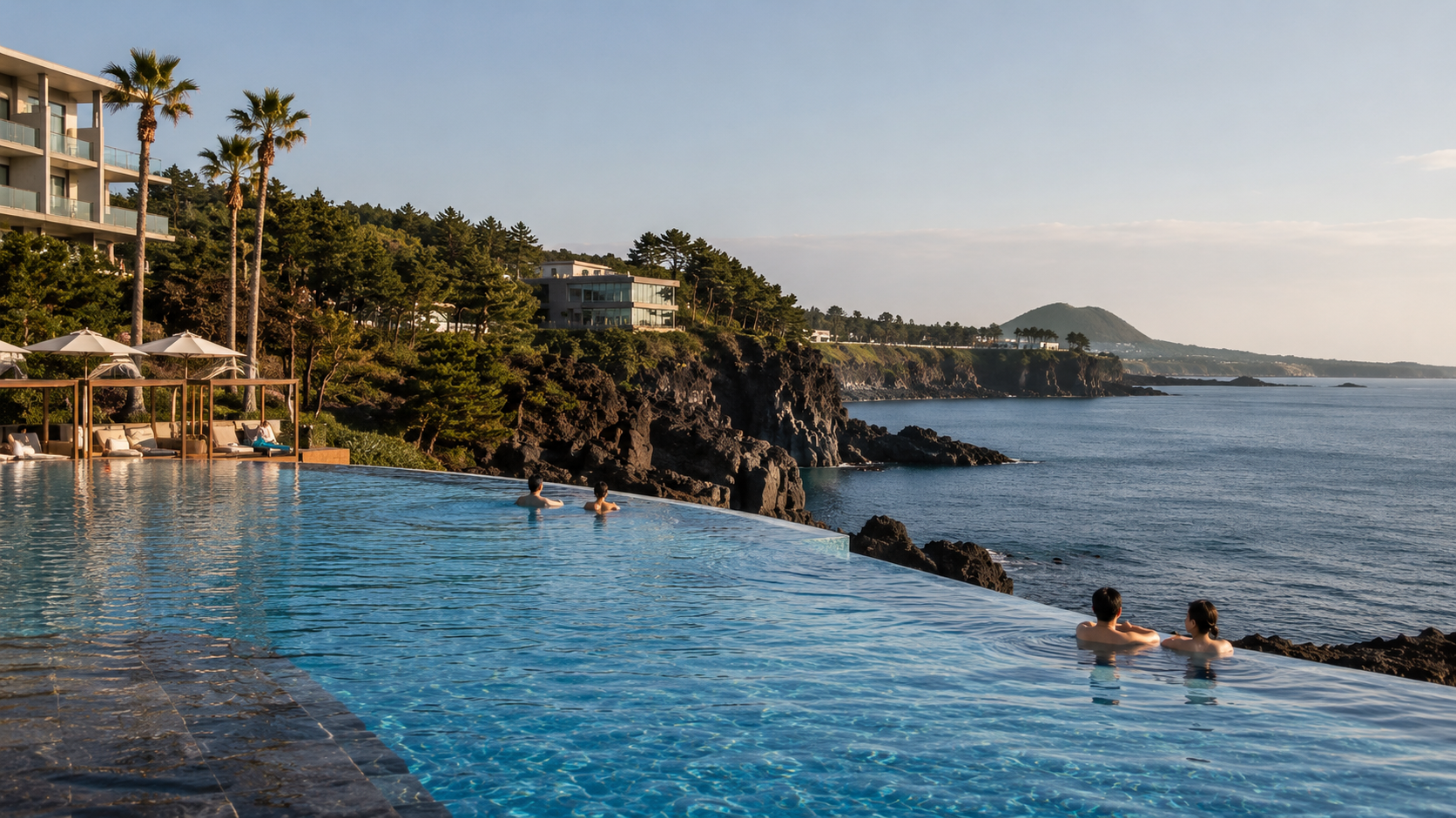 A Jeju resort pool overlooking the rocky southern coastline near Jungmun