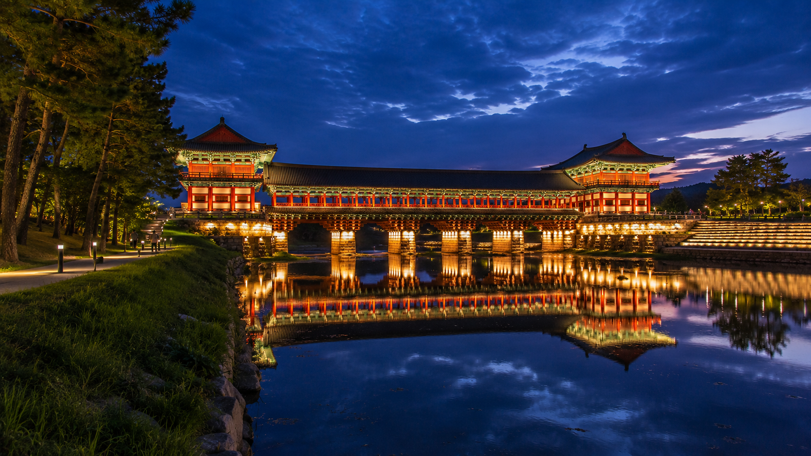 Illuminated Woljeonggyo Bridge reflected in the Namcheon Stream at blue hour