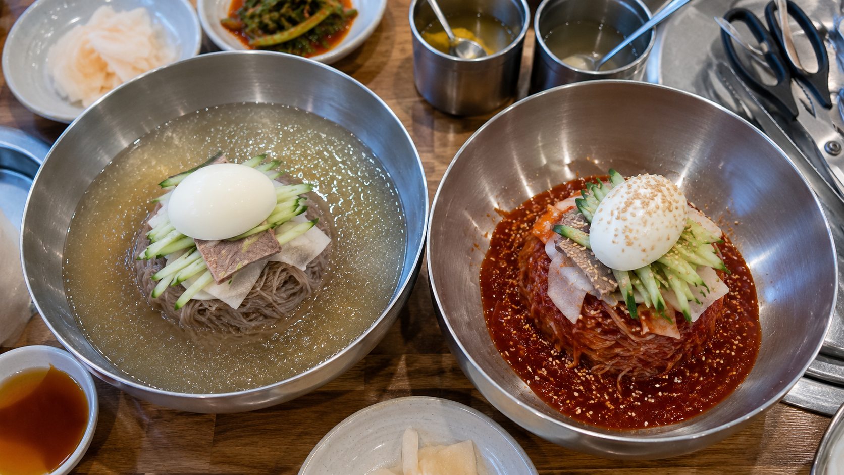 Mul-naengmyeon and bibim-naengmyeon served side by side at a Korean restaurant in summer