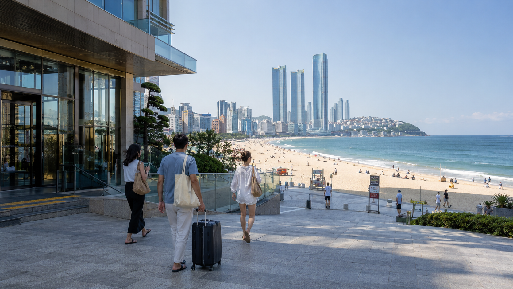 Travelers walking from a beachfront hotel onto Haeundae Beach in Busan